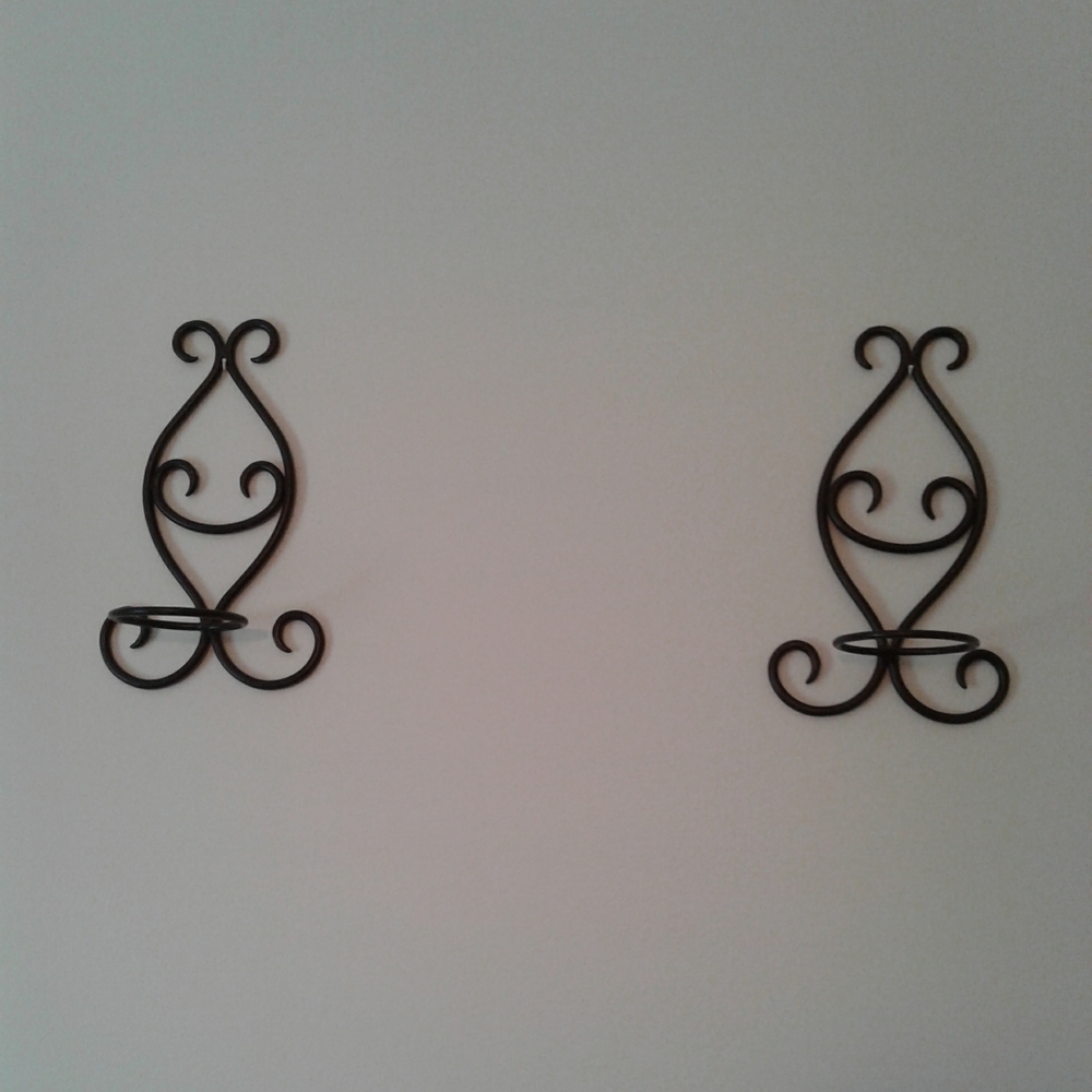 Set of 2 metal scrolled hanging candle holders.